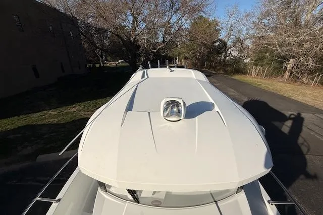 Slide: The Image of 2018 Jeanneau NC Sport 695 boat, top view, parked outdoors on a sunny day. - 6