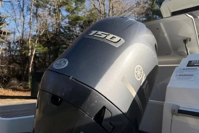 Slide: The Image of 2018 Jeanneau NC Sport 695 with Yamaha 150 outboard motor in a wooded setting. - 7