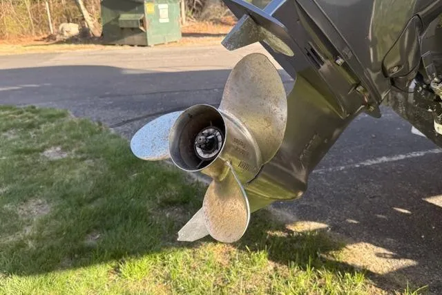 Slide: The Image of Propeller of a 2018 Jeanneau NC Sport 695 boat on grass near pavement. - 8