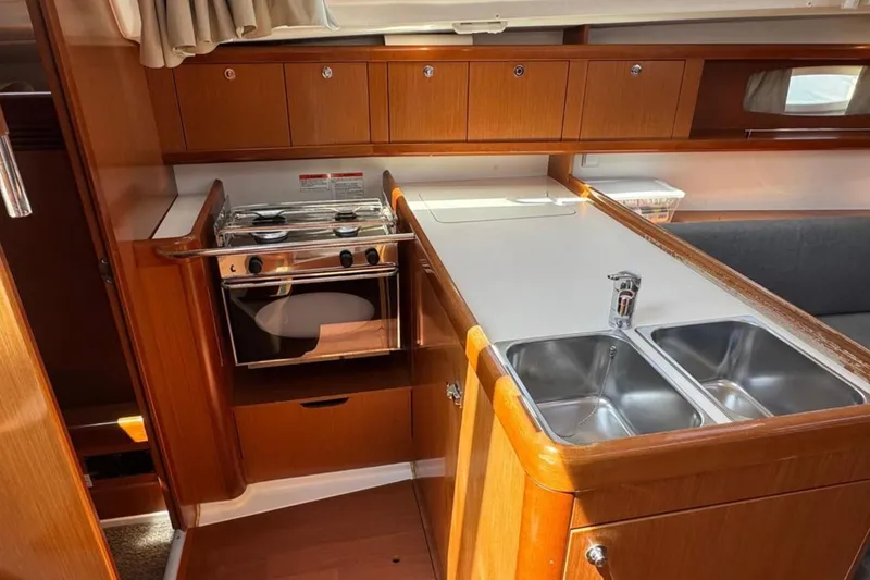 Slide: The Image of Interior of 2010 Beneteau Oceanis 37 yacht kitchen with stove and double sink. - 11
