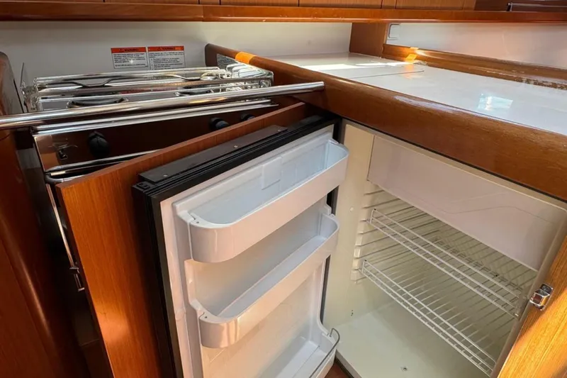 Slide: The Image of Beneteau Oceanis 37 yacht kitchen with open fridge and stove, 2010 model. - 12