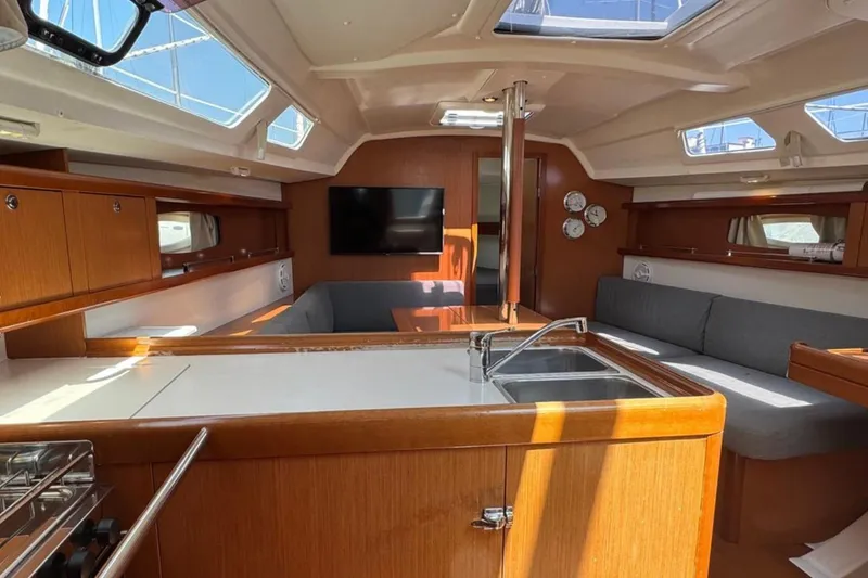 Slide: The Image of Interior of 2010 Beneteau Oceanis 37 sailboat with modern kitchen and seating area. - 13
