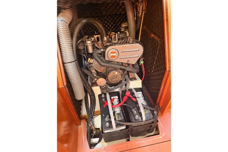 Slide: The Image of Engine compartment of a 2010 Beneteau Oceanis 37 sailboat, featuring batteries and hoses. - 21