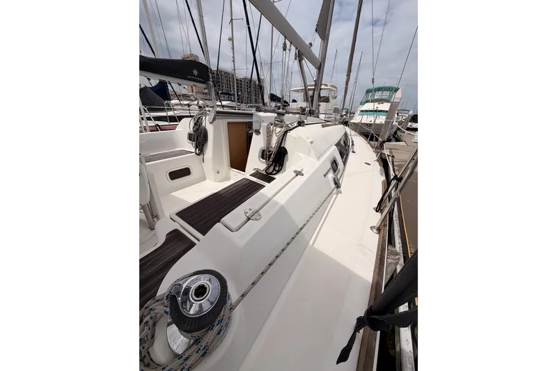 Slide: The Image of 2010 Beneteau Oceanis 34 sailboat docked at marina, showcasing deck and rigging. - 25
