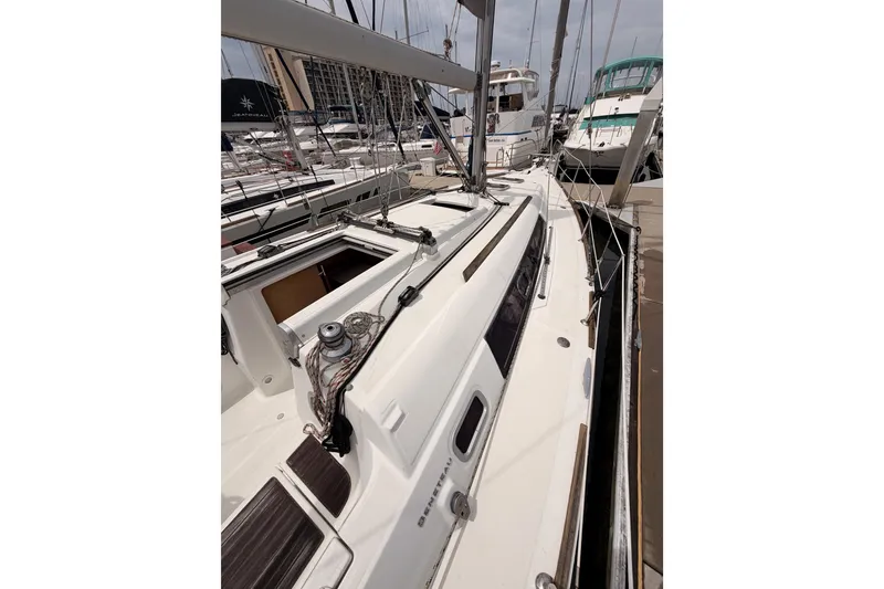 Slide: The Image of 2010 Beneteau Oceanis 34 sailboat docked at marina, showcasing deck and rigging. - 26