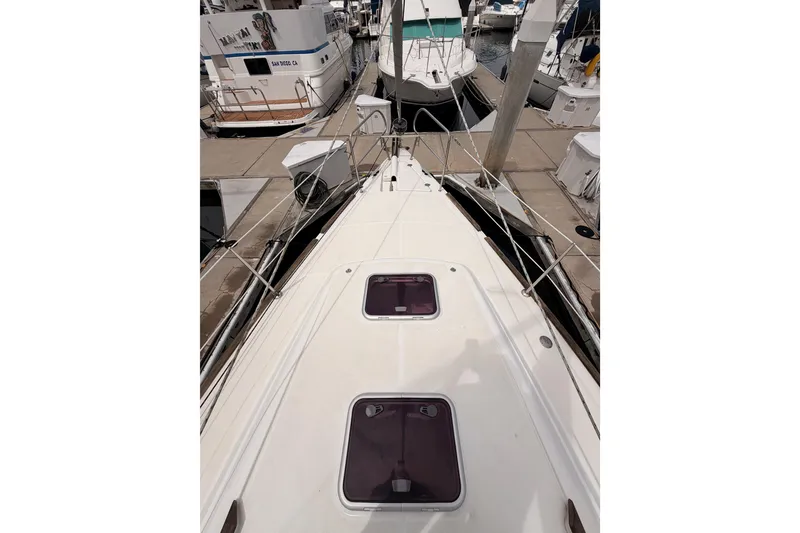 Slide: The Image of 2010 Beneteau Oceanis 34 sailboat docked at marina, view from deck. - 27