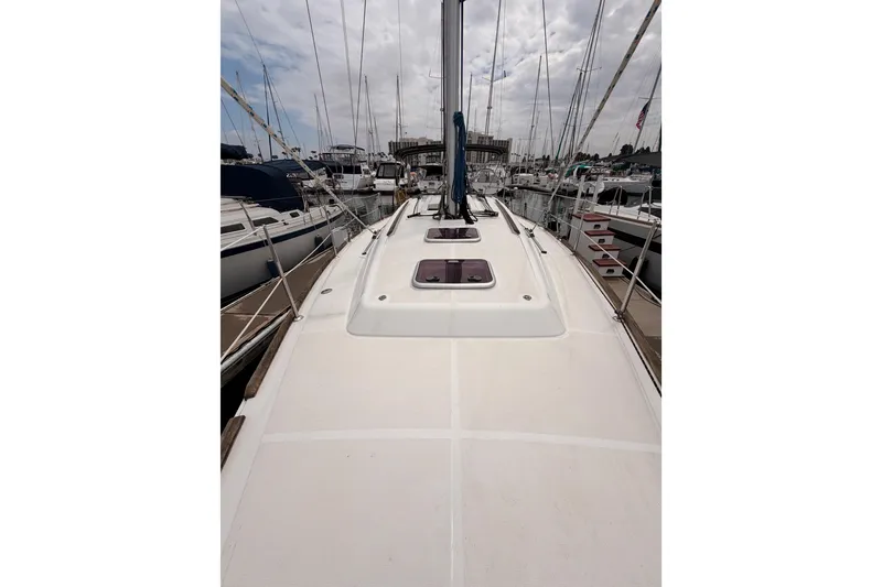 Slide: The Image of 2010 Beneteau Oceanis 34 sailboat docked in a marina, view of the deck. - 29