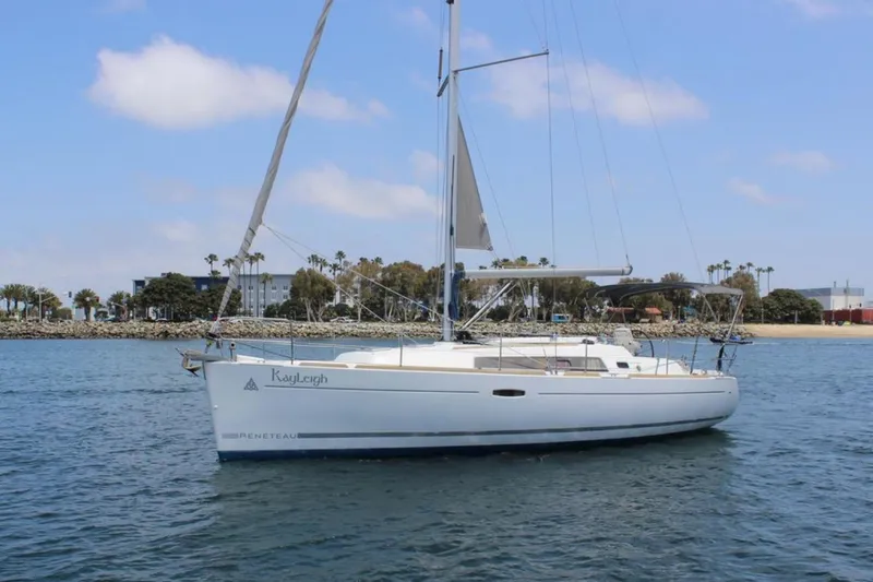 Slide: The Image of 2010 Beneteau Oceanis 37 sailboat on calm water, clear sky background. - 3