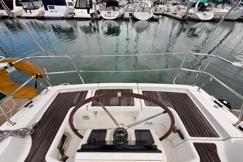 Slide: The Image of Cockpit view of a 2010 Beneteau Oceanis 34 sailboat docked in a marina. - 31