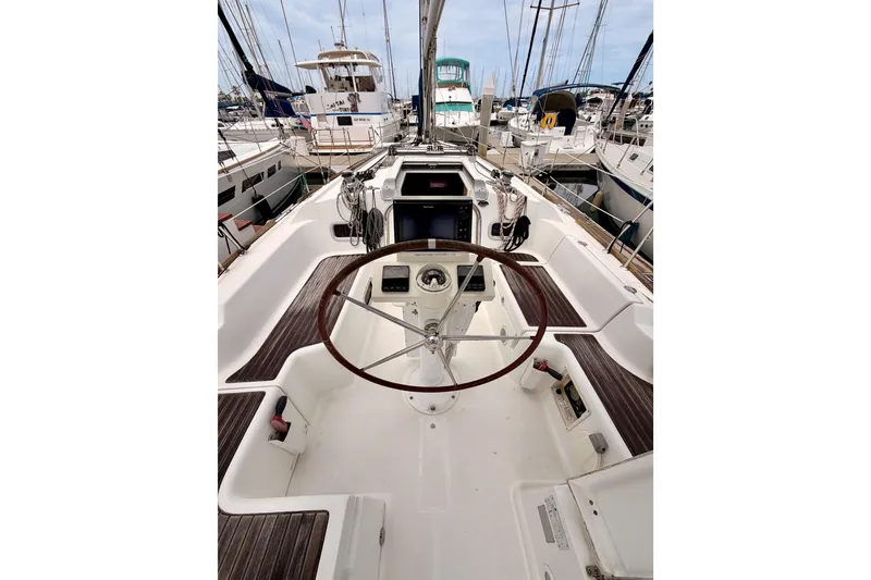 Slide: The Image of Cockpit view of 2010 Beneteau Oceanis 34 sailboat in marina setting. - 34