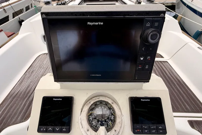 Slide: The Image of Raymarine navigation system on 2010 Beneteau Oceanis 34 sailboat, featuring compass and control panels. - 35