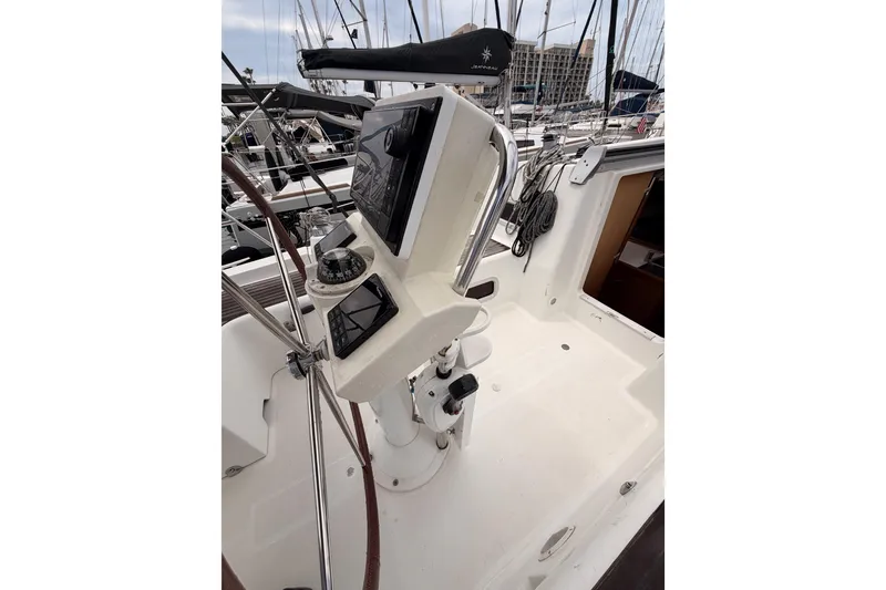 Slide: The Image of Cockpit of 2010 Beneteau Oceanis 34 sailboat with steering wheel and navigation instruments. - 36