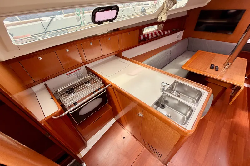 Slide: The Image of Interior of 2010 Beneteau Oceanis 34 yacht with kitchen and seating area. - 39