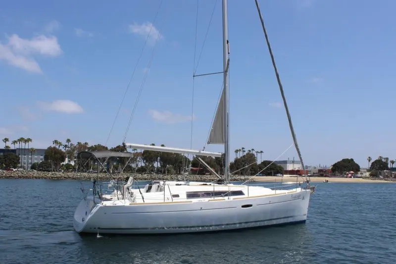 Slide: The Image of 2010 Beneteau Oceanis 37 sailboat on calm water, clear sky background. - 4
