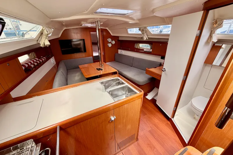 Slide: The Image of Interior of 2010 Beneteau Oceanis 34 yacht with cozy seating and modern amenities. - 47
