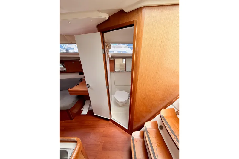 Slide: The Image of Interior of 2010 Beneteau Oceanis 34 yacht showing wooden cabin and bathroom. - 48