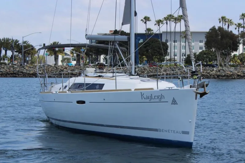 Slide: The Image of 2010 Beneteau Oceanis 37 sailboat on water, dockside view with palm trees. - 5