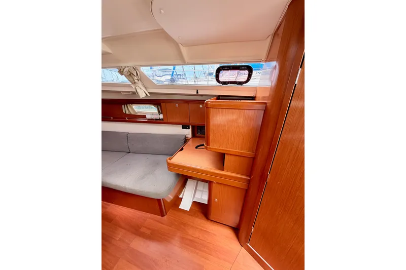 Slide: The Image of Interior of 2010 Beneteau Oceanis 34 sailboat with wooden cabinetry and seating area. - 51