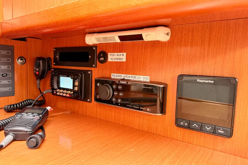 Slide: The Image of Control panel of a 2010 Beneteau Oceanis 34 yacht with navigation and communication equipment. - 54