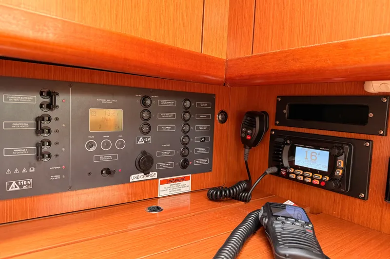 Slide: The Image of Control panel and radio equipment inside a 2010 Beneteau Oceanis 34 sailboat. - 55