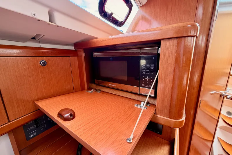 Slide: The Image of Interior of 2010 Beneteau Oceanis 34 yacht featuring a built-in microwave. - 56