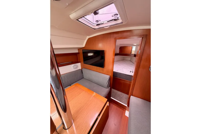 Slide: The Image of Interior of 2010 Beneteau Oceanis 34 yacht with cozy seating and wooden finishes. - 59