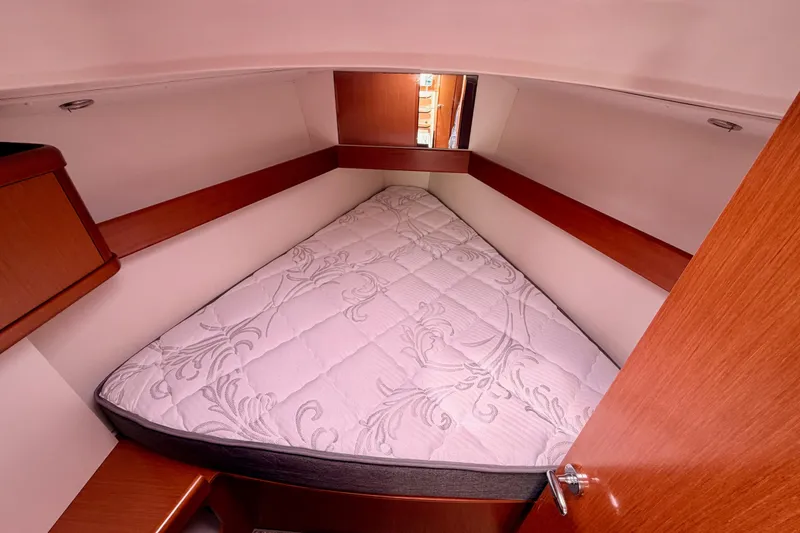 Slide: The Image of Cozy cabin interior of 2010 Beneteau Oceanis 34 sailboat with a comfortable bed. - 61