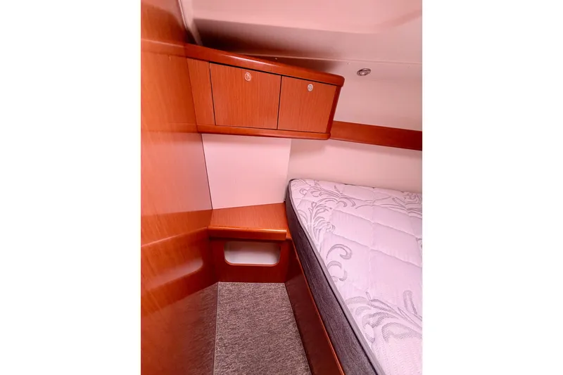 Slide: The Image of Cozy cabin interior of 2010 Beneteau Oceanis 34 sailboat with wooden cabinetry and mattress. - 62