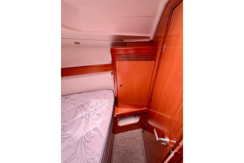 Slide: The Image of Cozy cabin interior of 2010 Beneteau Oceanis 34 sailboat with wooden cabinetry and bed. - 63