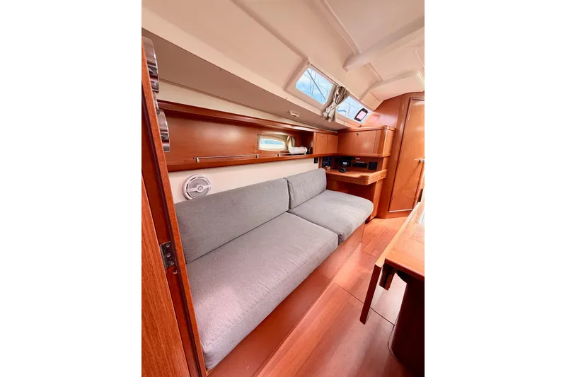 Slide: The Image of Interior of 2010 Beneteau Oceanis 34 sailboat with cozy seating and wooden finishes. - 64