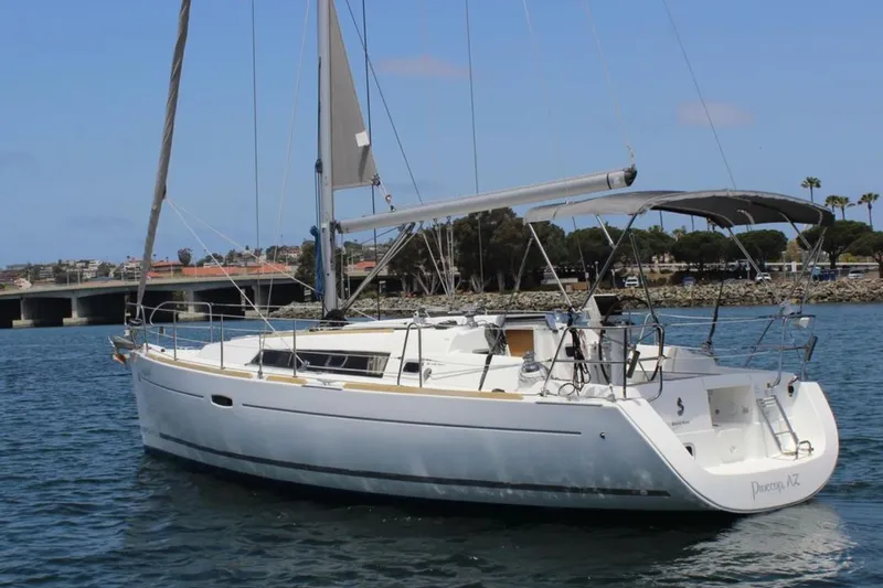 Slide: The Image of 2010 Beneteau Oceanis 37 sailboat on calm water, featuring sleek design and spacious deck. - 7