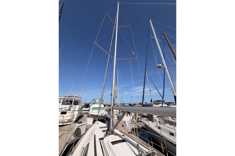 Slide: The Image of Sailboat Beneteau Oceanis 37, 2010 model, docked at marina under clear blue sky. - 8
