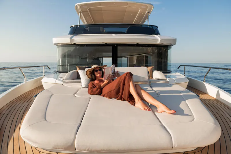 Slide: The Image of Woman relaxing on 2026 Absolute 62' Navetta yacht, enjoying the sun and sea. - 11