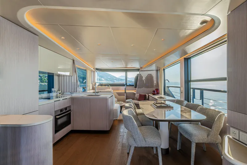 Slide: The Image of Luxurious interior of 2026 Absolute 62' Navetta yacht with modern kitchen and dining area. - 14