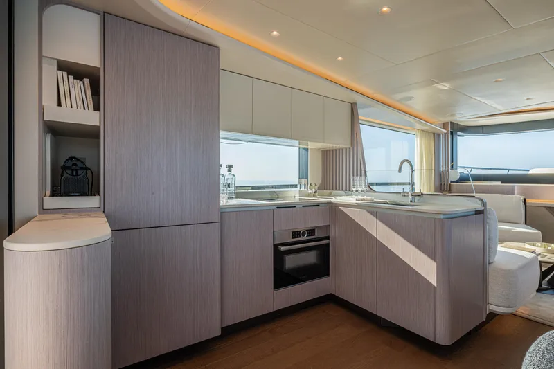 Slide: The Image of Modern kitchen interior on 2026 Absolute 62' Navetta yacht, featuring sleek cabinetry and ocean views. - 15