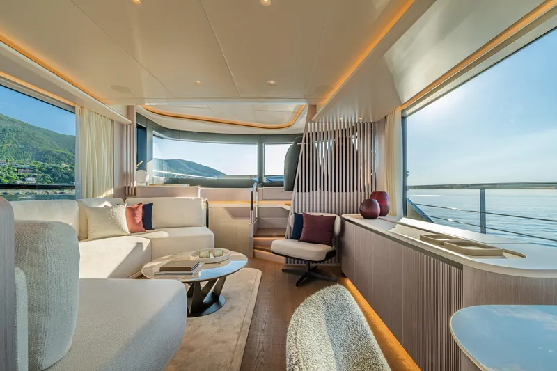 Slide: The Image of Luxurious interior of 2026 Absolute 62' Navetta yacht with panoramic windows and elegant furnishings. - 16