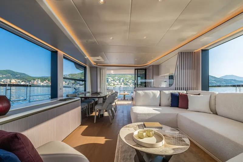 Slide: The Image of Luxurious interior of 2026 Absolute 62' Navetta yacht with panoramic windows and elegant furnishings. - 18