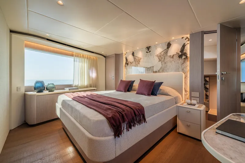 Slide: The Image of Luxurious bedroom interior on 2026 Absolute 62' Navetta yacht, featuring elegant decor and ocean view. - 21