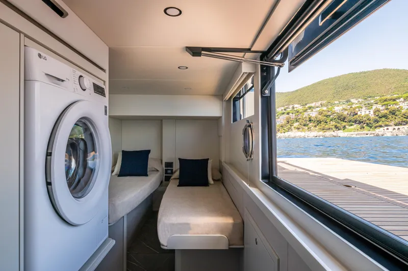Slide: The Image of Interior of 2026 Absolute 62' Navetta yacht with twin beds and washing machine. - 30