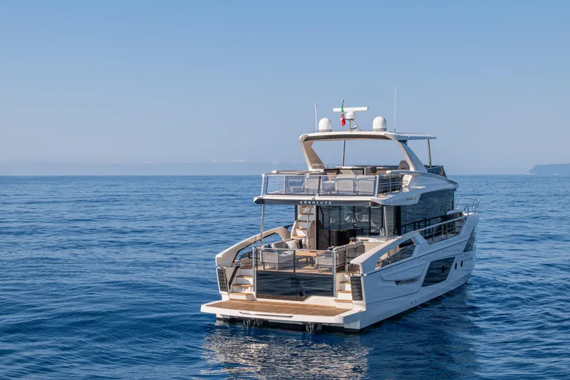 Slide: The Image of Luxurious 2026 Absolute 62' Navetta yacht cruising on calm blue ocean waters. - 5