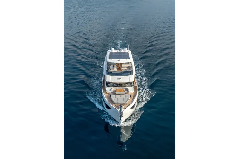 Slide: The Image of Aerial view of 2026 Absolute 62' Navetta yacht cruising on calm blue waters. - 6