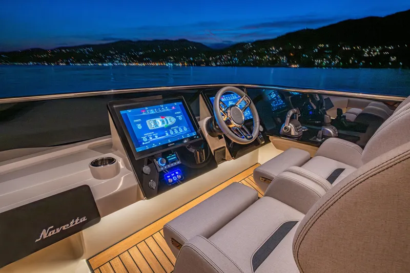 Slide: The Image of Luxurious helm of 2026 Absolute 62' Navetta yacht at dusk, featuring advanced navigation systems. - 9