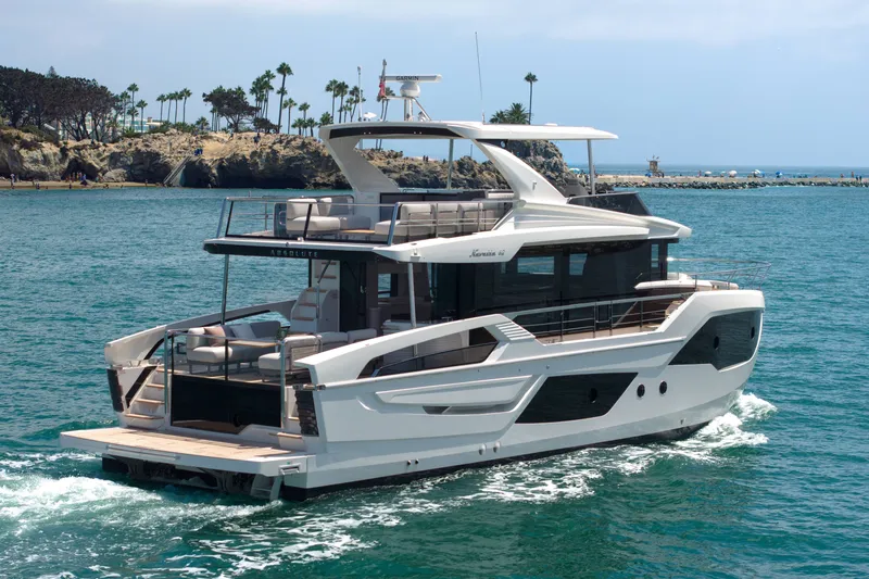 Slide: The Image of Luxury Absolute Navetta 62 yacht cruising in scenic coastal waters, 2027 model. - 2