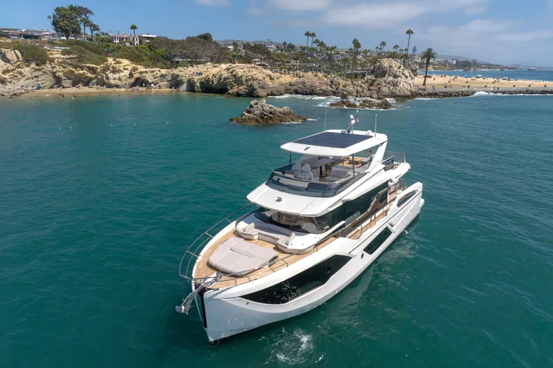 Slide: The Image of Luxurious 2027 Absolute Navetta 62 yacht cruising near a scenic coastline. - 10