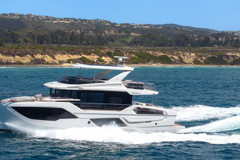 Slide: The Image of Luxurious 2027 Absolute Navetta 62 yacht cruising near scenic coastline. - 7