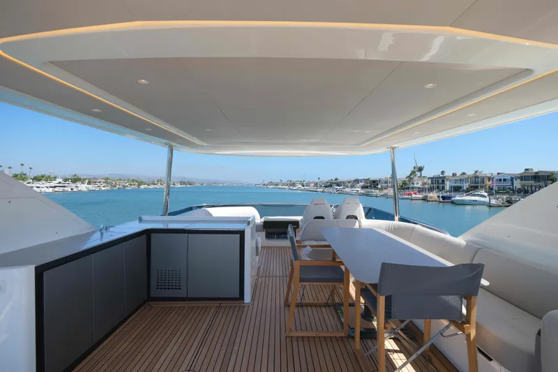 Slide: The Image of Luxurious 2027 Absolute Navetta 62 yacht deck with seating, overlooking serene marina views. - 14