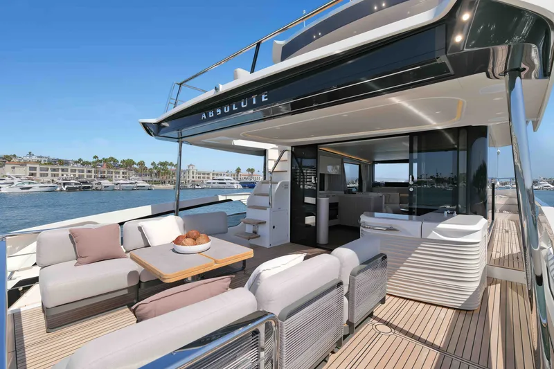Slide: The Image of Luxurious 2027 Absolute Navetta 62 yacht with spacious deck and elegant seating area. - 17