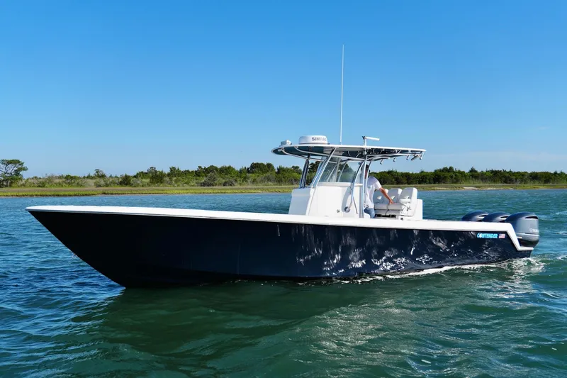 The Image of 2019 Contender 35 ST boat cruising on clear blue water under a sunny sky. - 0