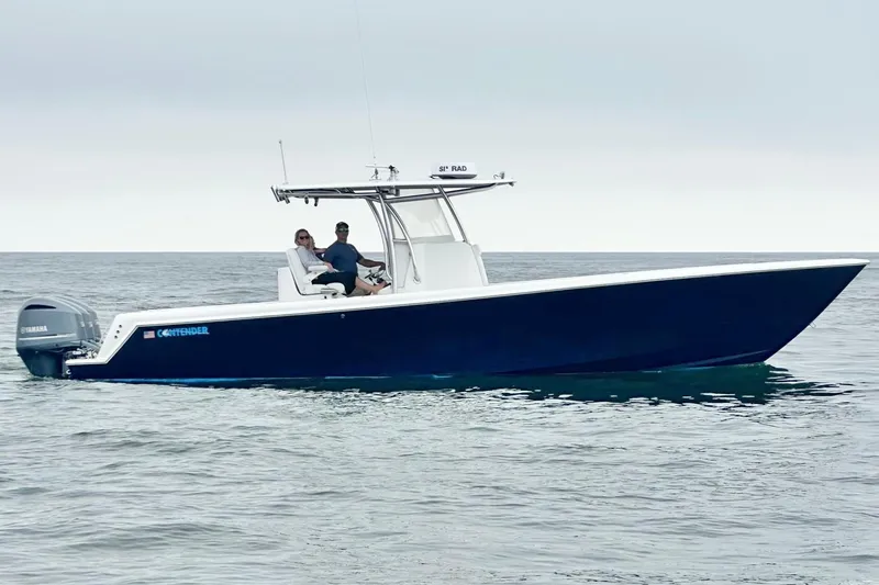 The Image of 2019 Contender 35 ST boat on calm ocean waters with two people onboard. - 1