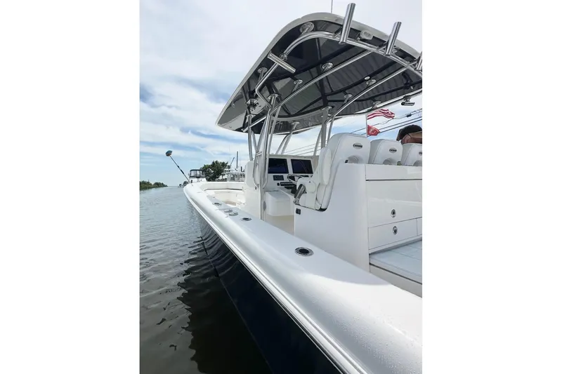 Slide: The Image of 2019 Contender 35 ST boat on water, featuring sleek design and modern console. - 10